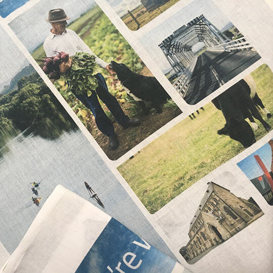 Tea towel with photographs printed on it.